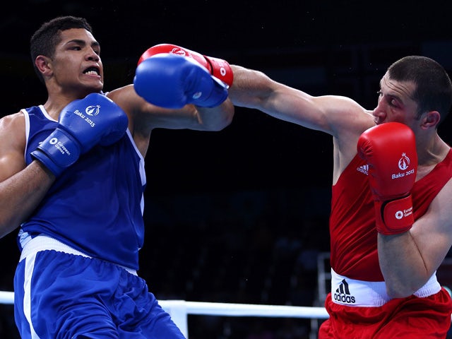 Abdulkadir Abdullayev of Azerbaijan (red) and Paul Omba Biongolo of France compete in the Men's Heavy Weight (91kg) Quarterfinal bout during day eleven of the Baku 2015 European Games at the Crystal Hall on June 23, 2015