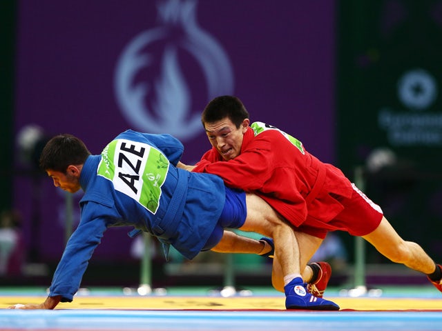 Aymergen Atkunov of Russia (red) and Islam Gasumov of Azerbaijan (blue) compete in the Men's Sambo -57kg Final during day ten of the Baku 2015 European Games at the Heydar Aliyev Arena on June 22, 2015