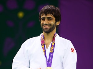 Gold medalist Beslan Mudranov of Russia poses on the medal podium following the Men's Judo -60kg Finals during day thirteen of the Baku 2015 European Games at the Heydar Aliyev Arena on June 25, 2015