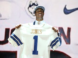 Byron Jones of the Connecticut Huskies holds up a jersey after being picked #27 overall by the Dallas Cowboys during the first round of the 2015 NFL Draft at the Auditorium Theatre of Roosevelt University on April 30, 2015
