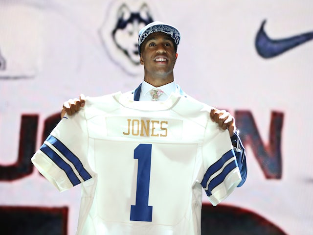 Byron Jones of the Connecticut Huskies holds up a jersey after being picked #27 overall by the Dallas Cowboys during the first round of the 2015 NFL Draft at the Auditorium Theatre of Roosevelt University on April 30, 2015
