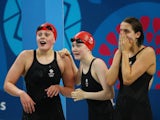 Team GB swimmers Holly Hibbott, Hannah Featherstone and Darcy Deakin react during the women's 4x200m freestyle relay at the European Games on June 27, 2015