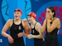 Team GB swimmers Holly Hibbott, Hannah Featherstone and Darcy Deakin react during the women's 4x200m freestyle relay at the European Games on June 27, 2015