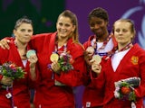 Silver medalist Volha Namazava of Belarus, gold medalist Ivana Jandric of Serbia and bronze medalists Celine Conde of France and Olga Zakhartsonva of Russia pose during the medal ceremony for the Women's Sambo -67kg on day ten of the Baku 2015 European Ga