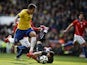 Brazil's midfielder Roberto Firmino (L) takes the ball past Chile's goalkeeper Claudio Bravo (2nd R) to score the only goal of the friendly international football match between Brazil and Chile at The Emirates Stadium in London on March 29, 2015