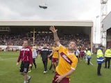 Scott McDonald of Motherwell throws his shoes into the crowd during the Scottish Premiership play-off final 2nd leg between Motherwell and Rangers at Fir Park on May 31, 2015