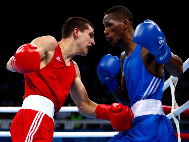 Viktor Petrov (red) of Ukraine and Collazo Sotomayor (blue) of Azerbaijan compete during the Men's Boxing Light Welter (64kg) semi final on day thirteen of the Baku 2015 European Games at the Crystal Hall on June 25, 2015