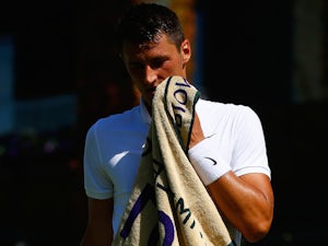 Tomic victorious in rain-affected opener