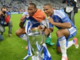 Chelsea's Ivorian forward Didier Drogba (L) and Chelsea's French midfielder Florent Malouda pose with the trophy after the UEFA Champions League final football match between FC Bayern Munchen and Chelsea FC on May 19, 2012