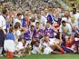 The French team celebrates with the FIFA trophy 12 July at the Stade de France in Saint-Denis, after France defeated Brazil 3-0 in the 1998 World Cup final
