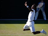 France's Gael Monfils jumps to return the ball to Spain's Pablo Carreno-Busta during their men's singles first round match on day two of the 2015 Wimbledon Championships at The All England Tennis Club in Wimbledon, southwest London, on June 30, 2015