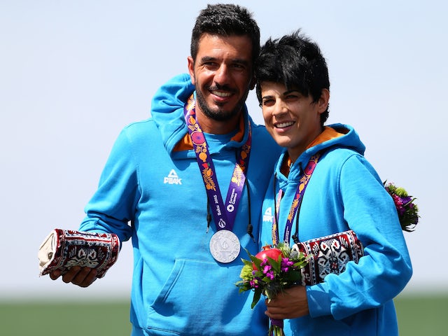Silver medalists Georgios Achilleos and Andri Eleftheriou of Cyprus stand on the podium during the medal ceremony for the Mixed Team Skeet Shooting on day ten of the Baku 2015 European Games at the Baku Shooting Centre on June 22, 2015