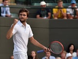 France's Gilles Simon reacts against France's Gael Monfils during their men's singles third round match on day six of the 2015 Wimbledon Championships at The All England Tennis Club in Wimbledon, southwest London, on July 4, 2015