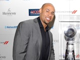 Former NFL player Hank Baskett poses with the Lombardi Trophy at the Tenth Annual Leather & Laces Super Bowl Party on February 1, 2013