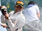Mercedes AMG Petronas F1 Team's British driver Lewis Hamilton celebrates on the podium after winning the British Formula One Grand Prix at the Silverstone circuit in Silverstone on July 5, 2015