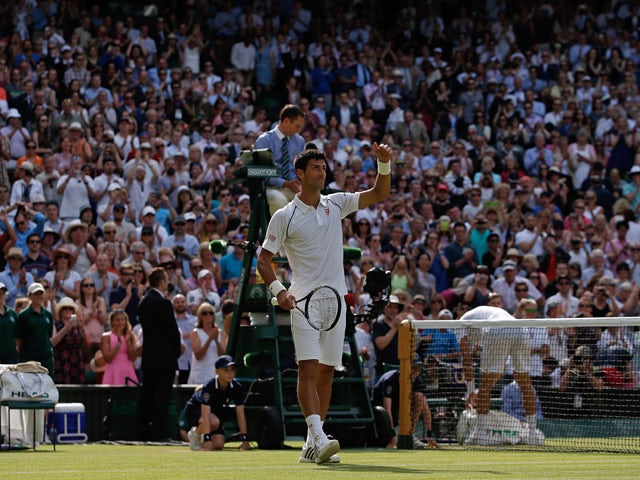 Serbia's Novak Djokovic celebrates after beating Australia's Bernard Tomic during their men's singles third round match on day five of the 2015 Wimbledon Championships at The All England Tennis Club in Wimbledon, southwest London, on July 3, 2015