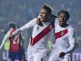 Peru's forward Paolo Guerrero celebrates with teammate Andre Carrillo after scoring against Paraguay during the Copa America third place football match in Concepcion, Chile on July 3, 2015