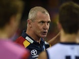 Phil Walsh the coach of the Crows speaks to his players during the round 13 AFL match between the Brisbane Lions and the Adelaide Crows at The Gabba on June 27, 2015 