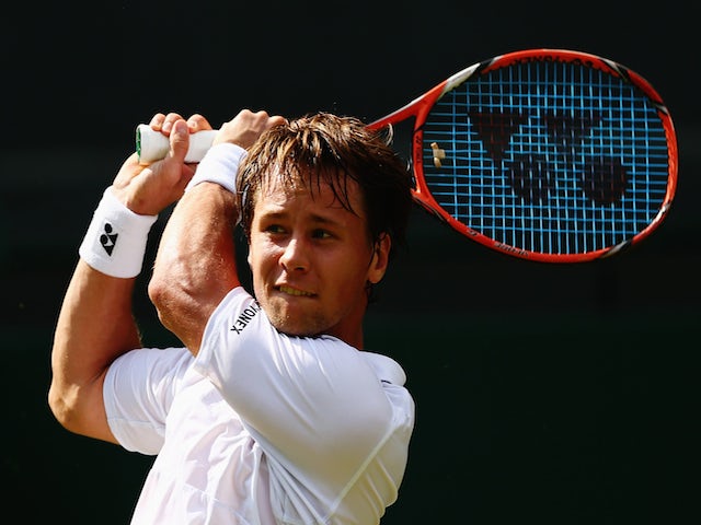 Ricardas Berankis of Lithuania plays a backhand in his Gentlemens Singles Second Round match against Marin Cilic of Croatia during day three of the Wimbledon Lawn Tennis Championships at the All England Lawn Tennis and Croquet Club on July 1, 2015