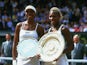 Wimbledon Ladies champion Serena Williams (right) of the USA poses with the winning trophy with runner-up and sister Venus Williams of the USA at the Wimbledon Lawn Tennis Championship held at the All England Lawn Tennis and Croquet Club in Wimbledon, Lon