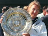 German top seed Steffi Graf holds her trophy after she won her seventh title after beating Arantxa Sanchez Vicario of Spain in the women 's singles final at the Wimbledon Tennis Championships 06 July 1996