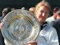 German top seed Steffi Graf holds her trophy after she won her seventh title after beating Arantxa Sanchez Vicario of Spain in the women 's singles final at the Wimbledon Tennis Championships 06 July 1996