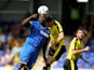 Adebayo Akinfenwa of AFC Wimbledon battles with Craig Cathcart of Watford during the Pre Season Friendly match between AFC Wimbledon and Watford at The Cherry Red Records Stadium on July 11, 2015