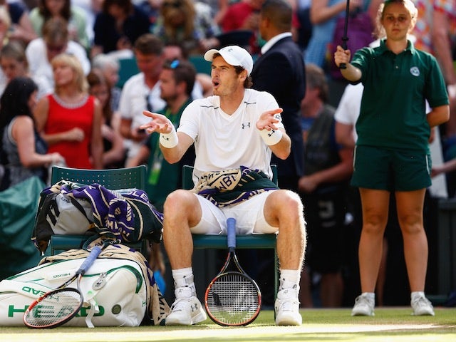 Andy Murray gestures to his team during the Wimbledon semi-final against Roger Federer on July 10, 2015