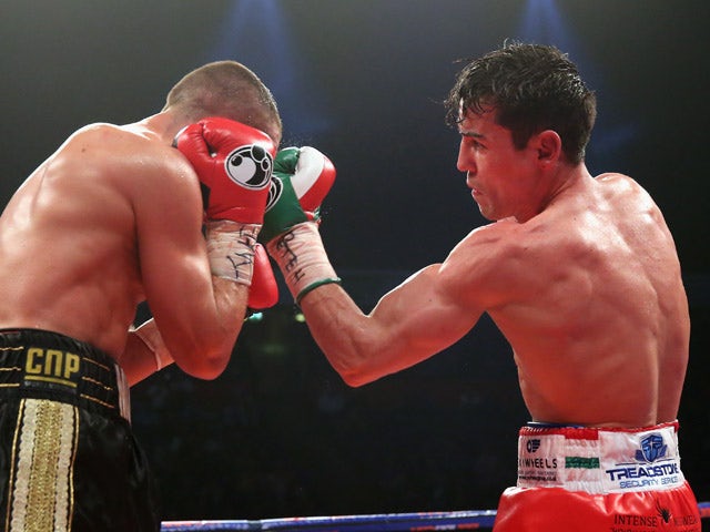 Anthony Crolla lands a left hook on John Murray during the WBO Inter-Continental Lightweight Title fight between Anthony Crolla John Murray at the Phones 4 U Arena on April 19, 2014
