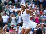 Garbine Muguruza of Spain celebrates match point in her Ladies Singles Quarter Final match against Timea Bacsinszky of Switzerland during day eight of the Wimbledon Lawn Tennis Championships at the All England Lawn Tennis and Croquet Club on July 7, 2015