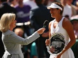 Garbine Muguruza of Spain holds the runner-up trophy after the Final Of The Ladies' Singles against Serena Williams of the United States during day twelve of the Wimbledon Lawn Tennis Championships at the All England Lawn Tennis and Croquet Club on July 1