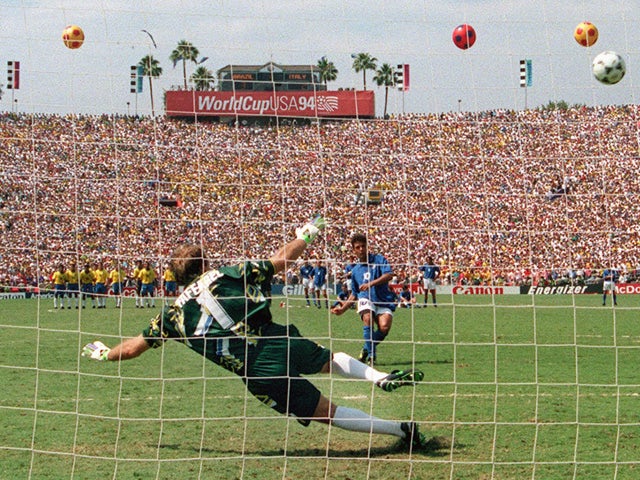 Brazilian goalkeeper Claudio Taffarel dives the wrong way as Italian midfielder Roberto Baggio's penalty kick goes over the crossbar during the shoot-out of the World Cup soccer final 17 July 1994