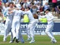 England's James Anderson (L) celebrates with teammates after taking the final wicket of Brad Haddin for 71 during play on the fifth day of the first Ashes cricket test match between England and Australia at Trent Bridge in Nottingham, central England on J