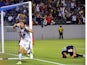Alan Gordon of the LA Galaxy celebrates after scoring the game-winning goal before the dejected Club America defender Paolo Goltz (R) on July 11, 2015