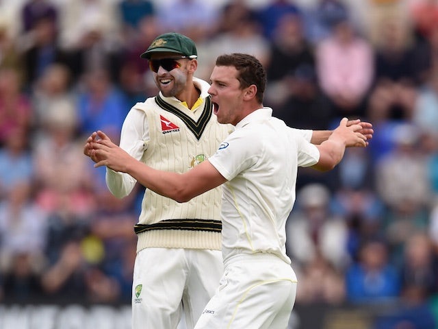 Nathan Lyon and Josh Hazlewood of Australia celebrate a wicket during day one of the first Test against England at the Swalec Stadium on July 8, 2015