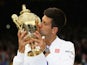 Novak Djokovic of Serbia celebrates with the trophy after winning the Final Of The Gentlemen's Singles against Roger Federer of Switzerland on day thirteen of the Wimbledon Lawn Tennis Championships at the All England Lawn Tennis and Croquet Club on July 