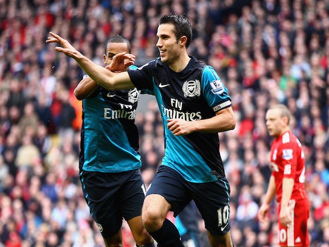 Robin van Persie of Arsenal celebrates scoring the equalising goal with teammate Theo Walcott (R) during the Barclays Premier League match between Liverpool and Arsenal at Anfield on March 3, 2012