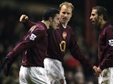 Arsenal's Robin Van Persie (L) celebrates his goal against Wigan with Dennis Bergkamp (C) and Mathieu Flamini during their Carling Cup match at Arsenal's grounds, 24 January 2006