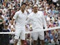 Serbia's Novak Djokovic (L) stands on court alongside Switzerland's Roger Federer ahead of their men's singles final match during the presentation on day thirteen of the 2014 Wimbledon Championships at The All England Tennis Club in Wimbledon, southwest L