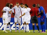 Teammates congratulate Clint Dempsey #8 of United States after he scored a goal as Frantz Bertin #6 of Haiti, right, disputes the call during the 2015 CONCACAF Gold Cup Group A match between United States and Haiti at Gillette Stadium on July 10, 2015