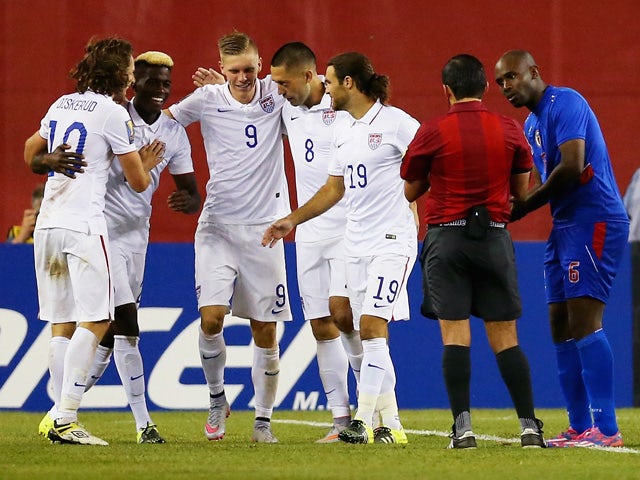 Teammates congratulate Clint Dempsey #8 of United States after he scored a goal as Frantz Bertin #6 of Haiti, right, disputes the call during the 2015 CONCACAF Gold Cup Group A match between United States and Haiti at Gillette Stadium on July 10, 2015