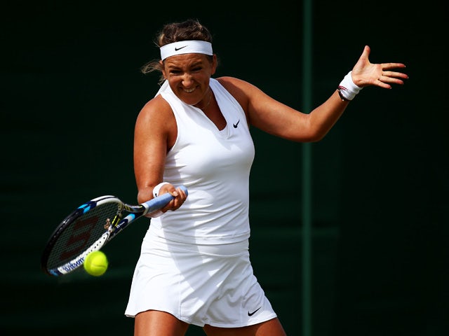 Victoria Azarenka of Belarus plays a forehand in her Ladies' Singles Fourth Round match against Belinda Bencic of Switzerland during day seven of the Wimbledon Lawn Tennis Championships at the All England Lawn Tennis and Croquet Club on July 6, 2015
