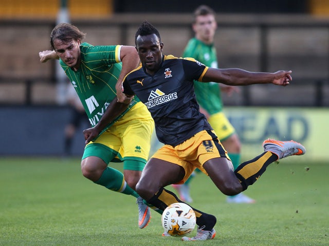 Jordon Slew of Cambridge United is tackled by Ignasi Miquel during the pre season friendly match between Cambridge United and Norwich City at the Abbey Stadium on July 17, 2015