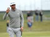 Dustin Johnson of the United States salutes the crowd on the 15th green during the first round of the 144th Open Championship at The Old Course on July 16, 2015