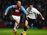 Freddie Ljungberg (L) of West Ham United is challenged by Simon Davies (R) of Fulham during the Barclays Premier League match between West Ham United and Fulham at Upton Park on January 12, 2008