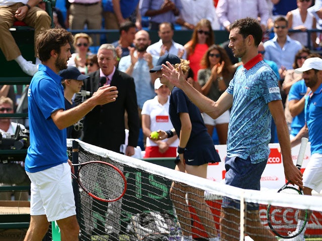 James Ward of Great Britain shakes hands at the net after his straight sets defeat against Gilles Simon of France during Day One of the World Group Quarter Final Davis Cup match between Great Britain and France at Queens Club on July 17, 2015