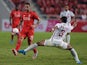 Liverpool football player Danny Ings (L) battles for the ball with Prathum Chuthong (R) of Thailand All Stars at Rajamangala stadium in Bangkok on July 14, 2015