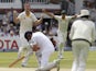 Australia's Mitchell Marsh (L) celebrates bowling out Englands Captain Alastair Cook (down) on the third day of the second Ashes cricket test match between England and Australia at Lord's cricket ground in London, on July 18, 2015