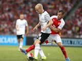 Steven Naismith of Everton keeps the ball away from Aaron Ramsey of Arsenal during the Barclays Asia Trophy match between Arsenal and Everton at the National Stadium on July 18, 2015