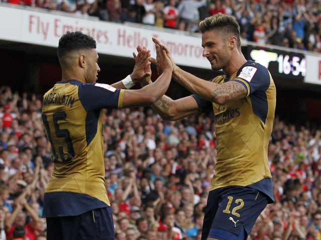 Arsenals English striker Alex Oxlade-Chamberlain celebrates scoring his goal with Arsenals French striker Olivier Giroud during the pre-season friendly football match between Arsenal and Lyon at The Emirates Stadium in north London on July 25, 2015
